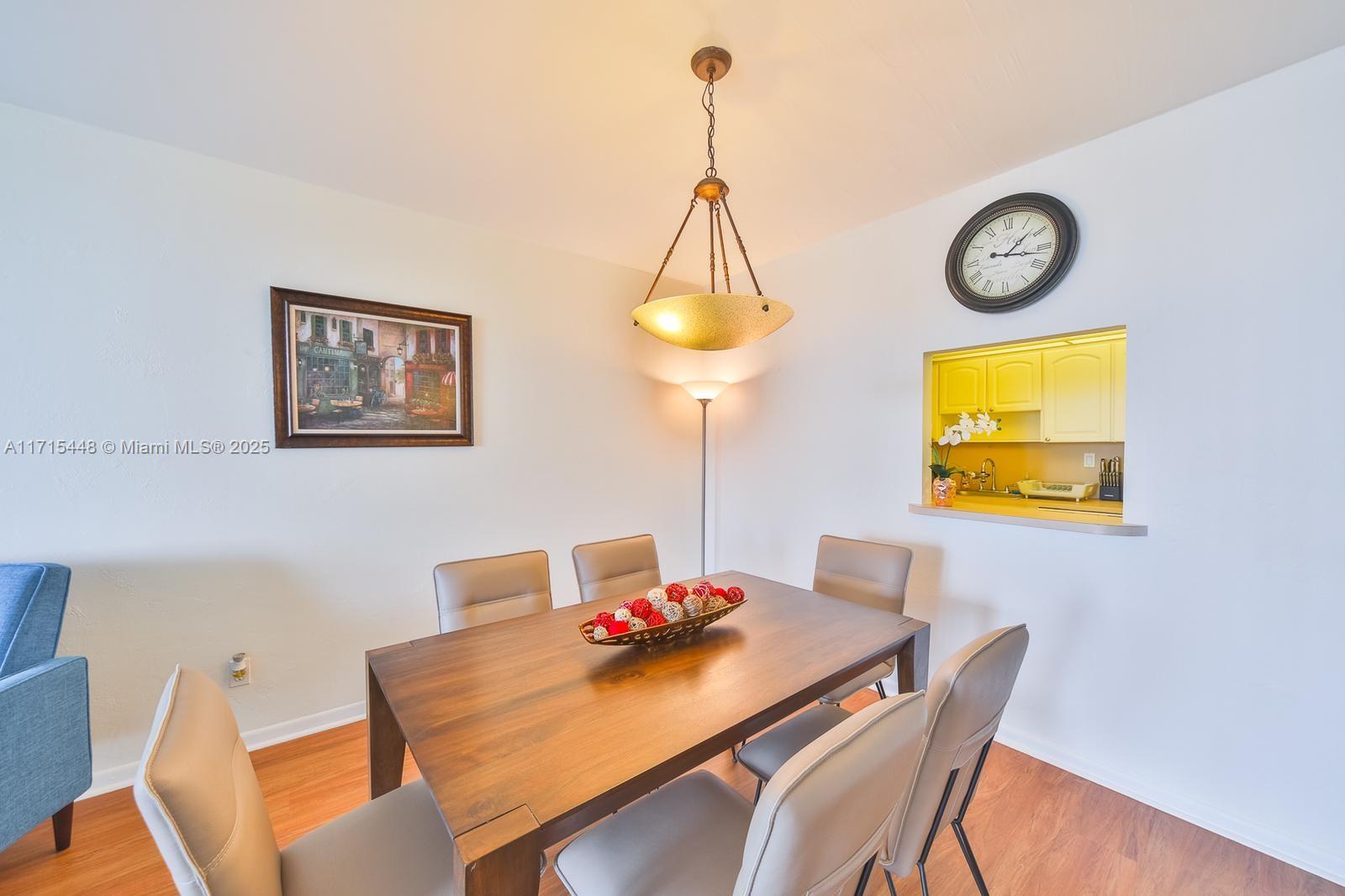 a view of a dining room with a table and chairs