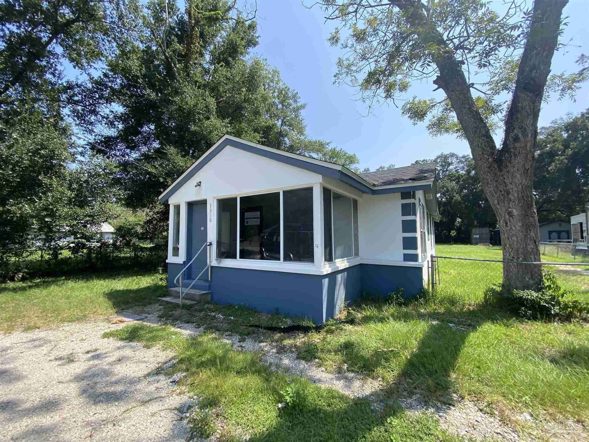 a front view of house with yard and green space