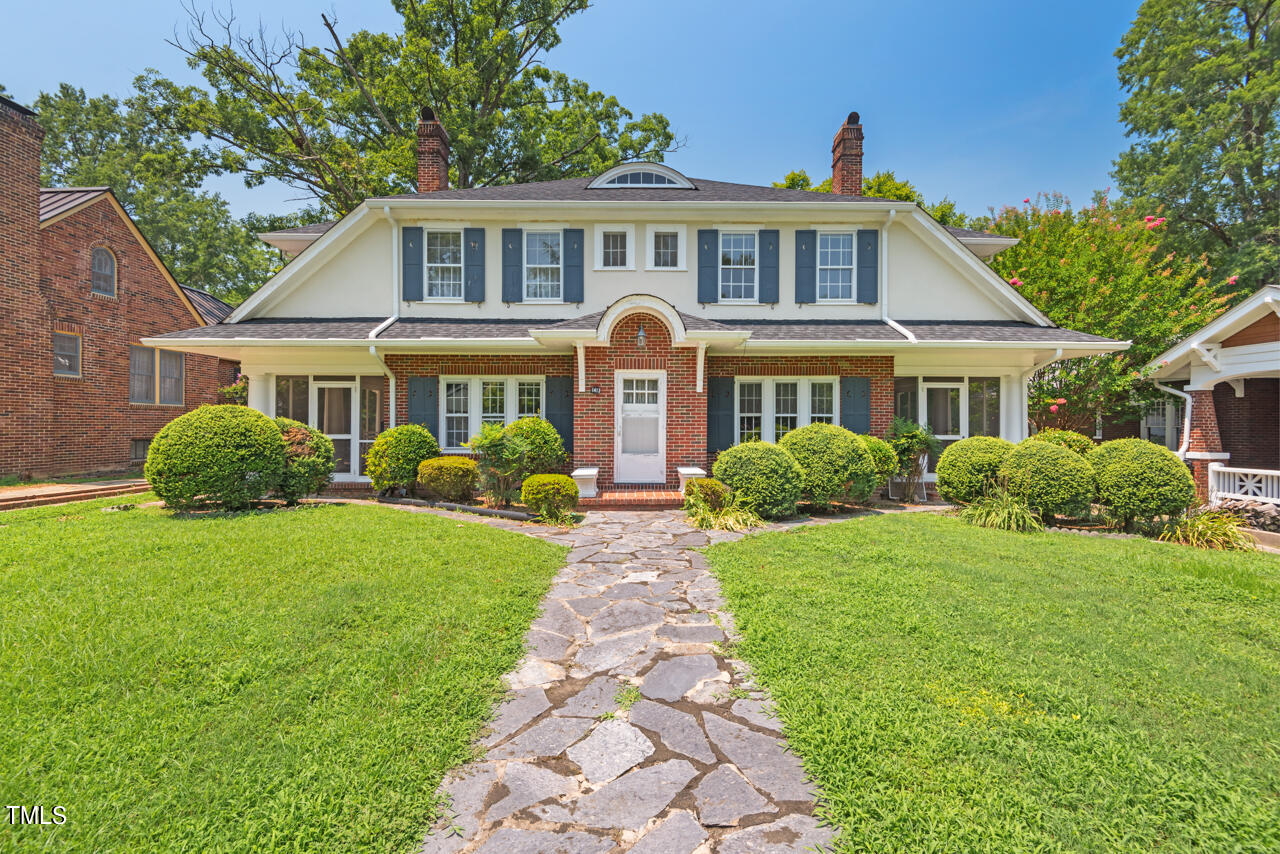 a front view of a house with a garden