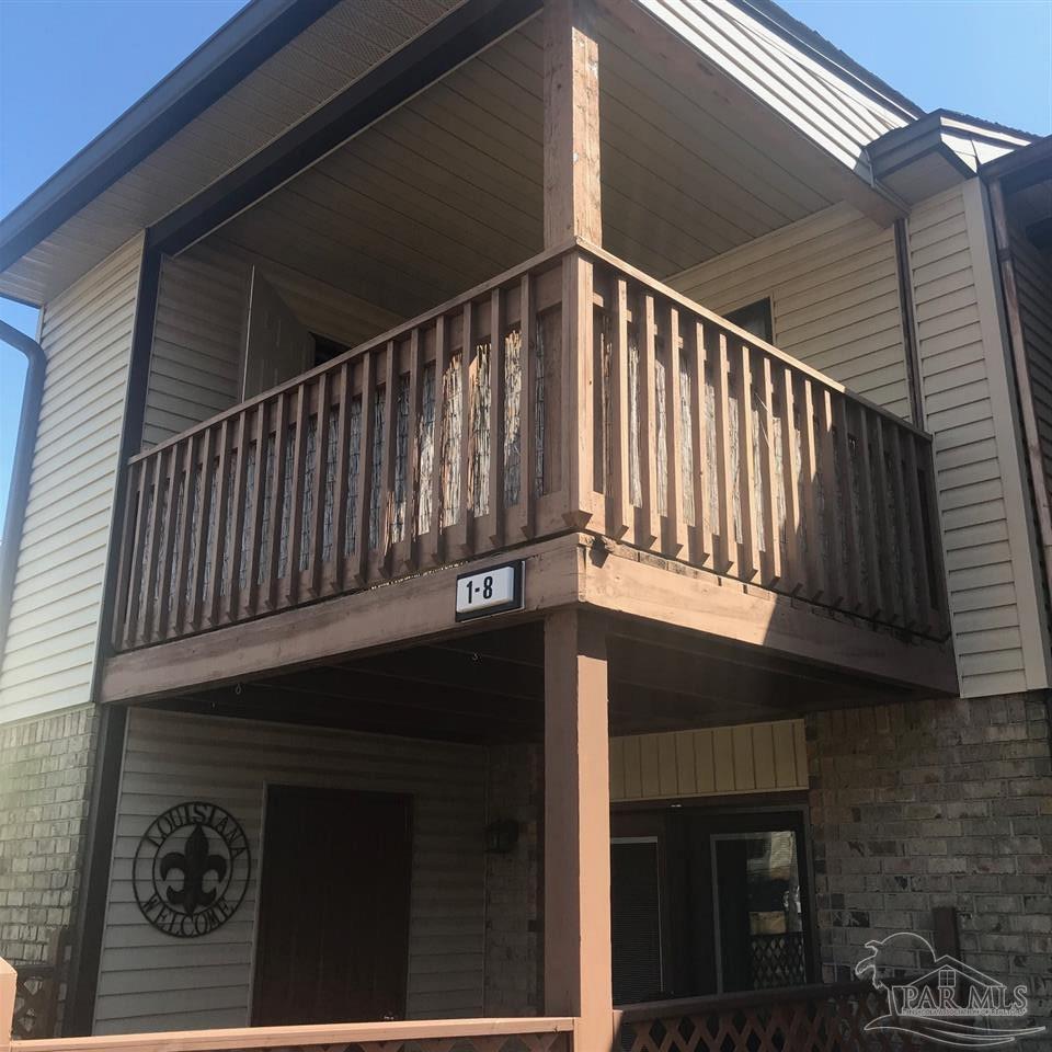 a view of a balcony with wooden floor