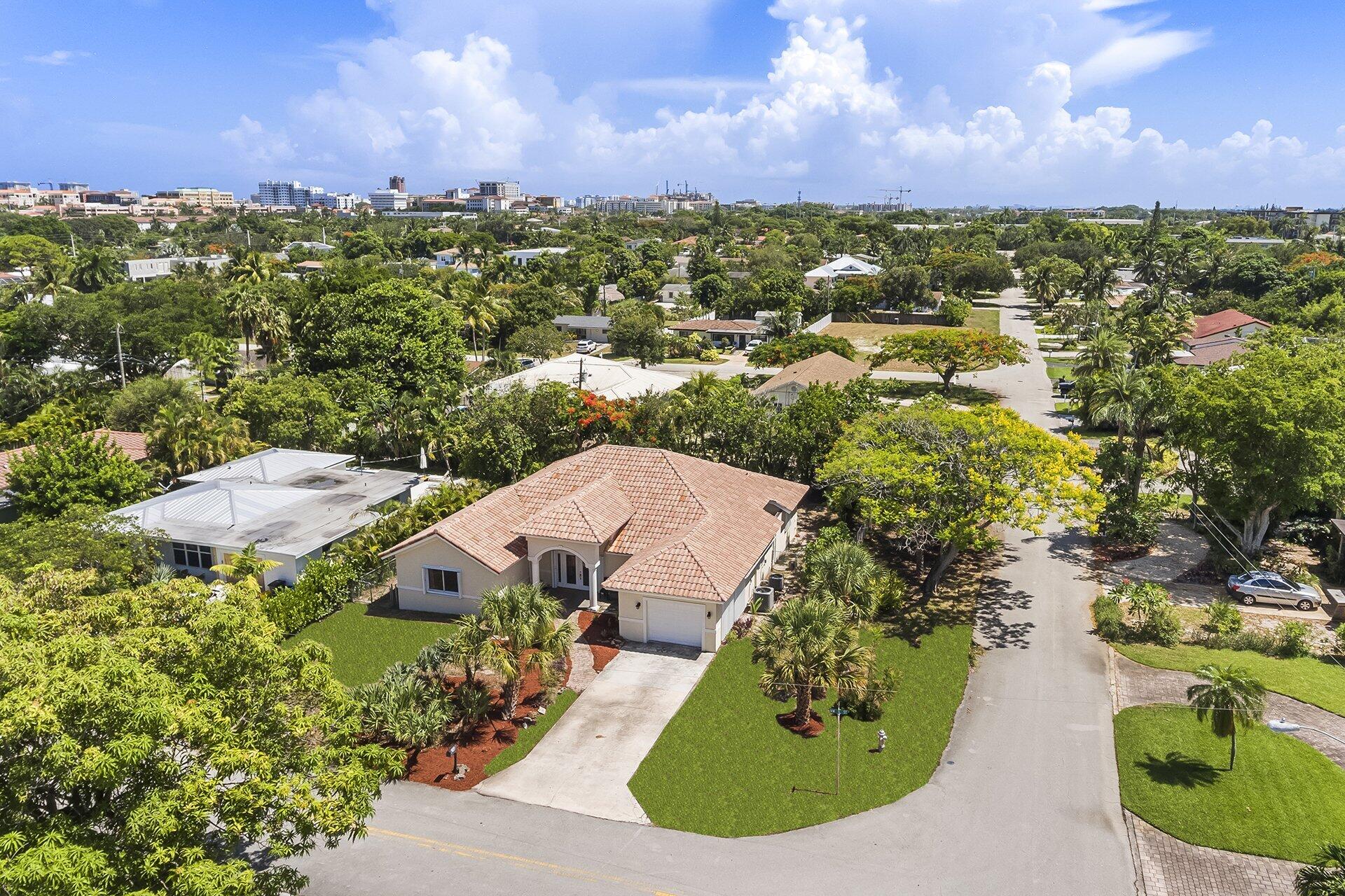 an aerial view of a house with a yard and lake view