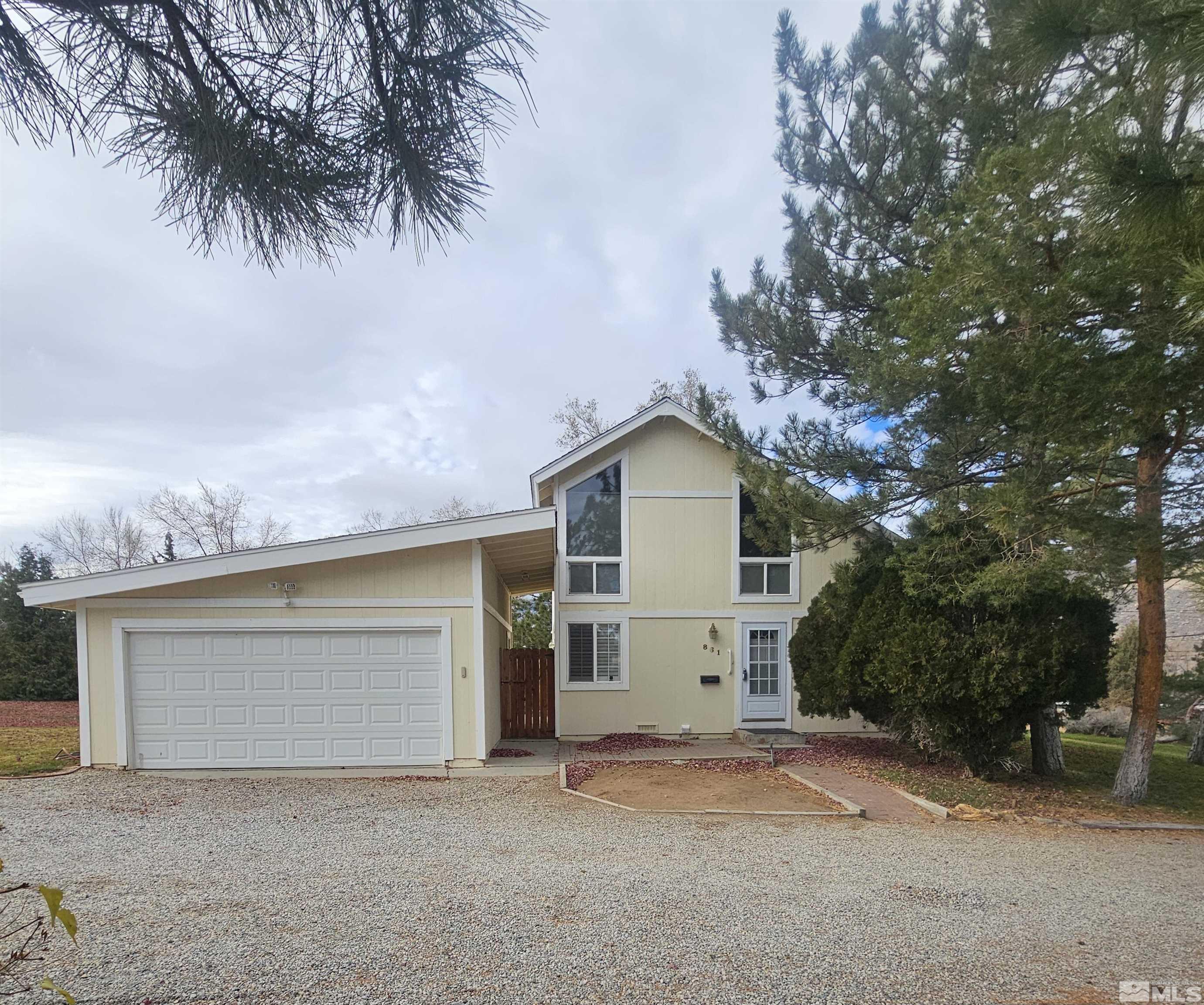 a view of a house with a yard and garage