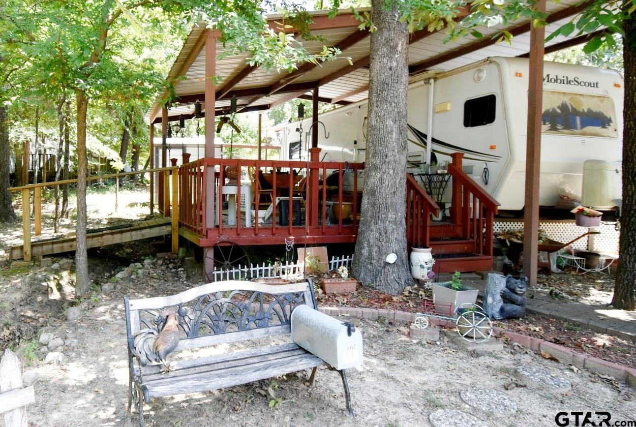 a view of a patio with a table chairs and a small yard