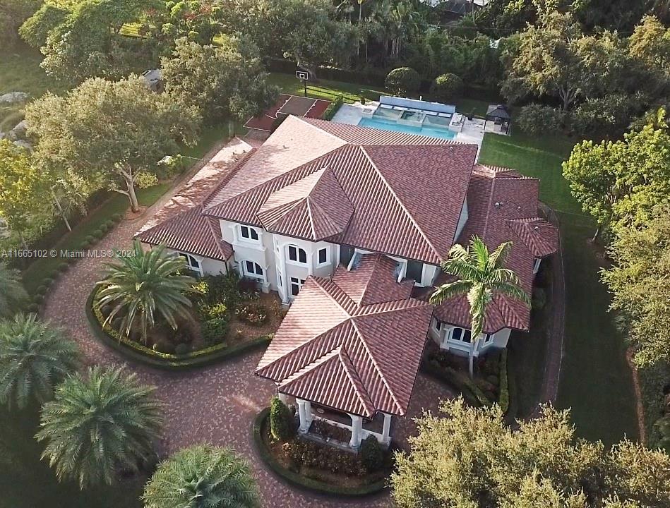 an aerial view of a house with garden space and lake view