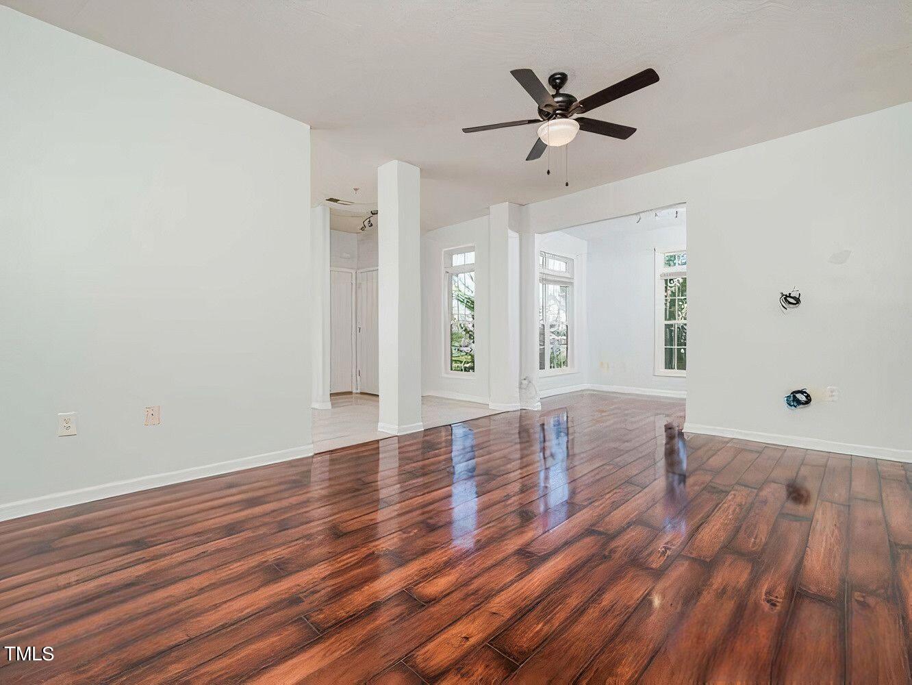 wooden floor in an empty room with a window