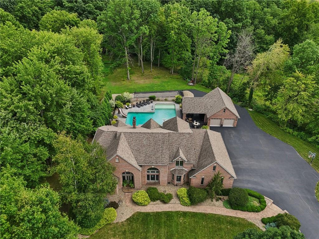 an aerial view of a house with garden space and street view