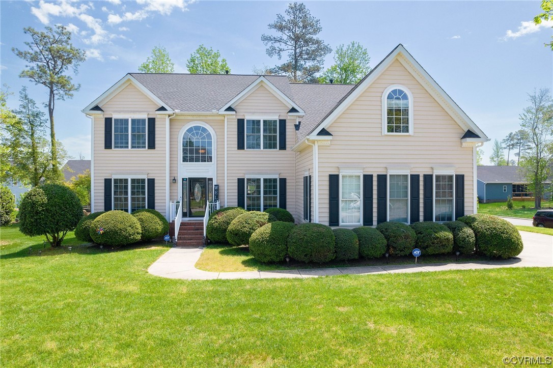 a front view of a house with a garden