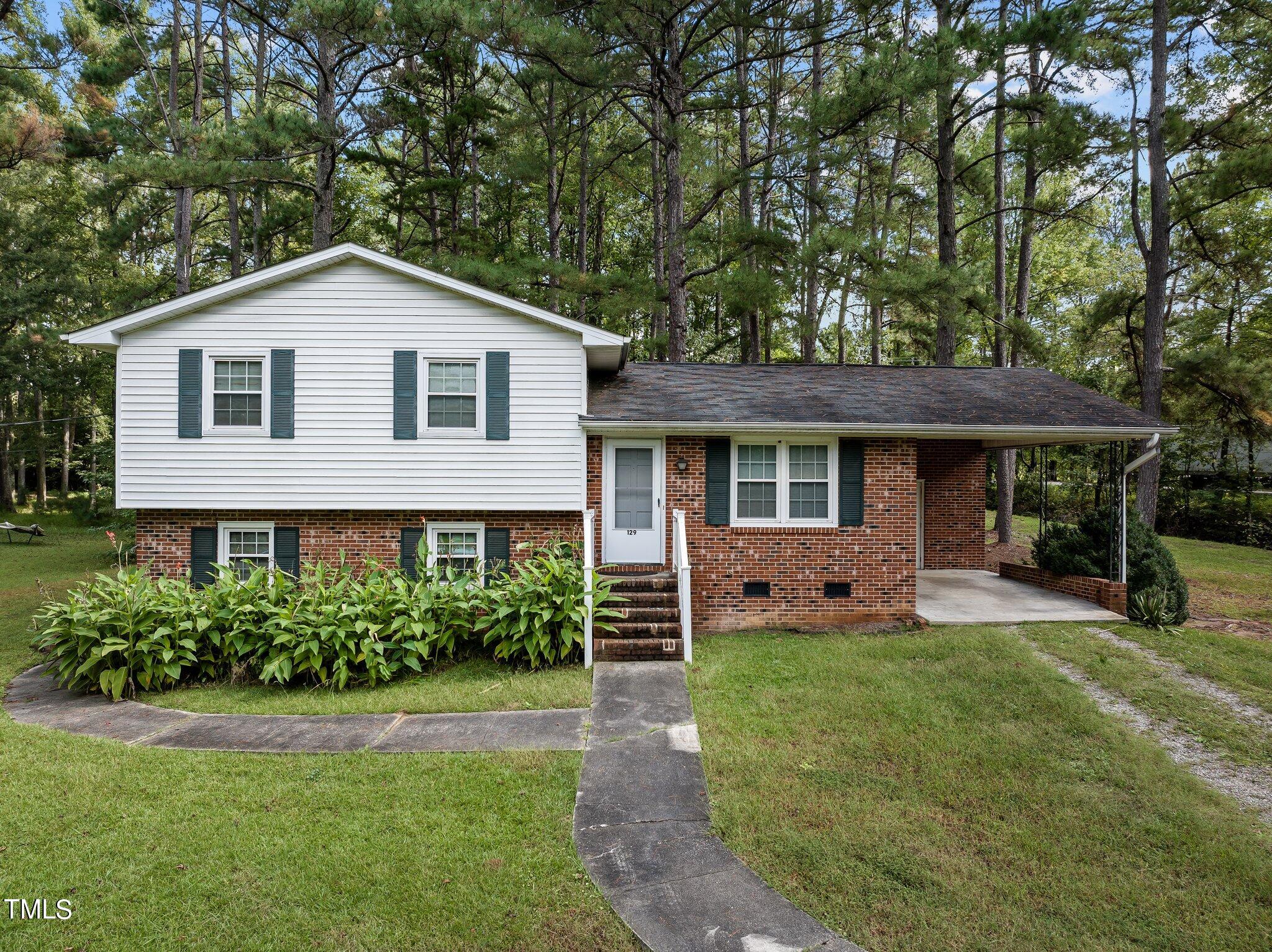 a front view of a house with a yard and porch