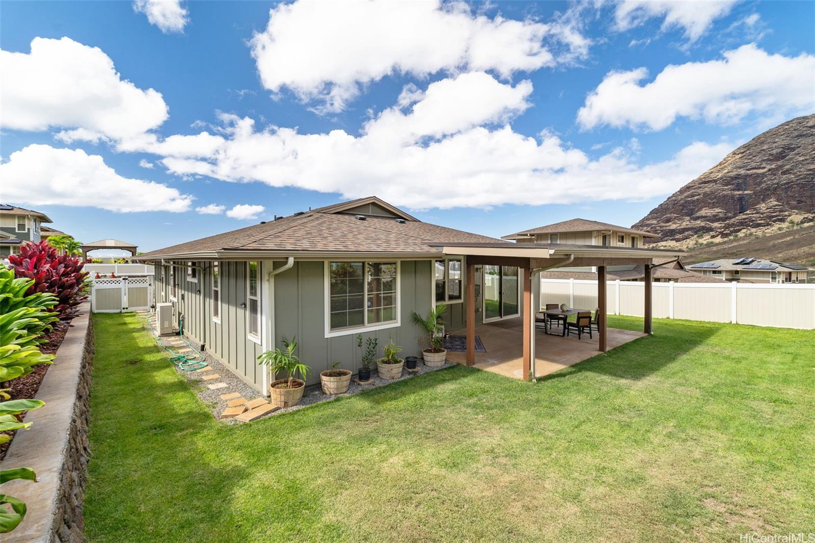 a view of a house with a yard and sitting area