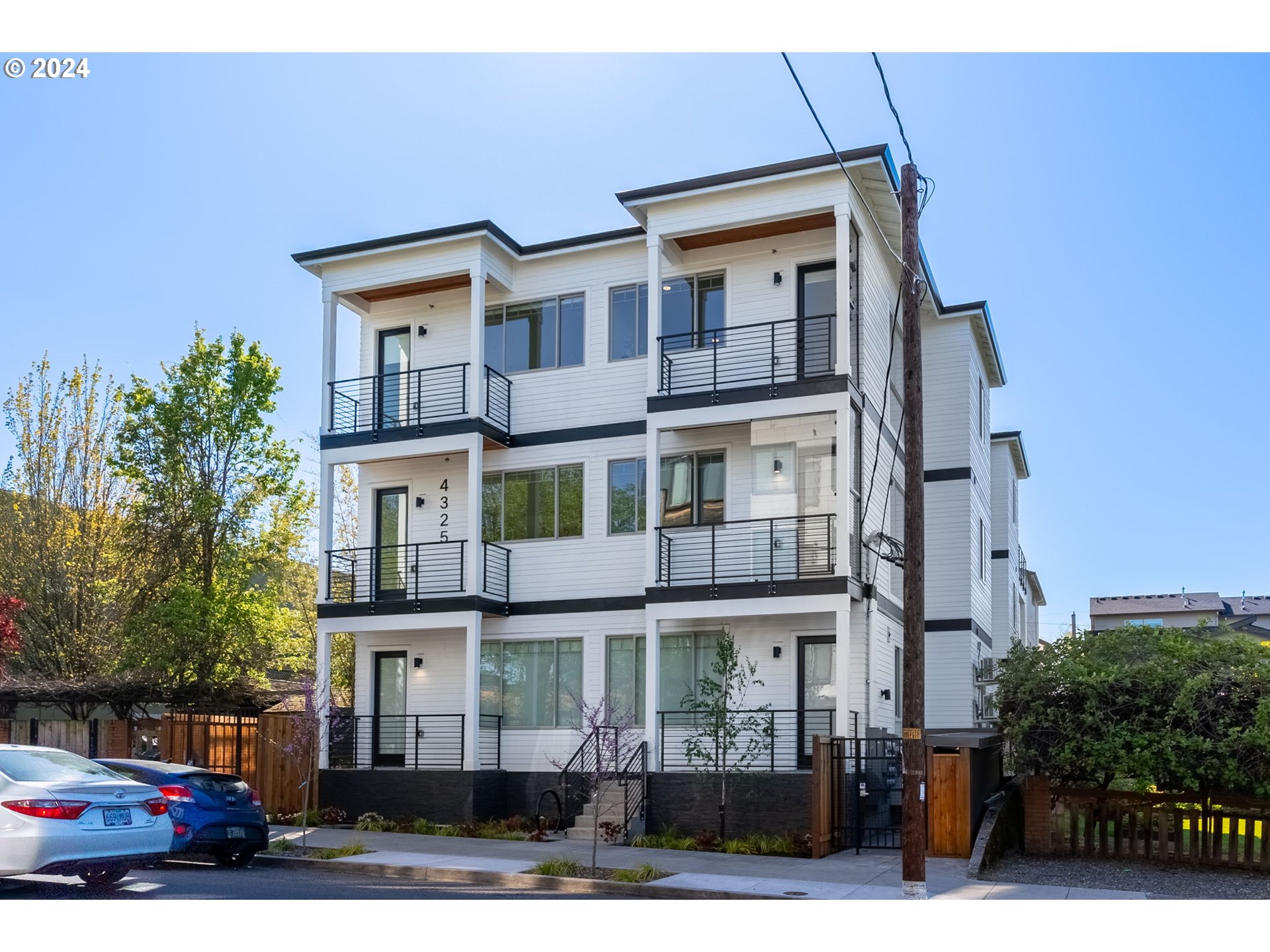 a front view of a residential apartment building with a yard