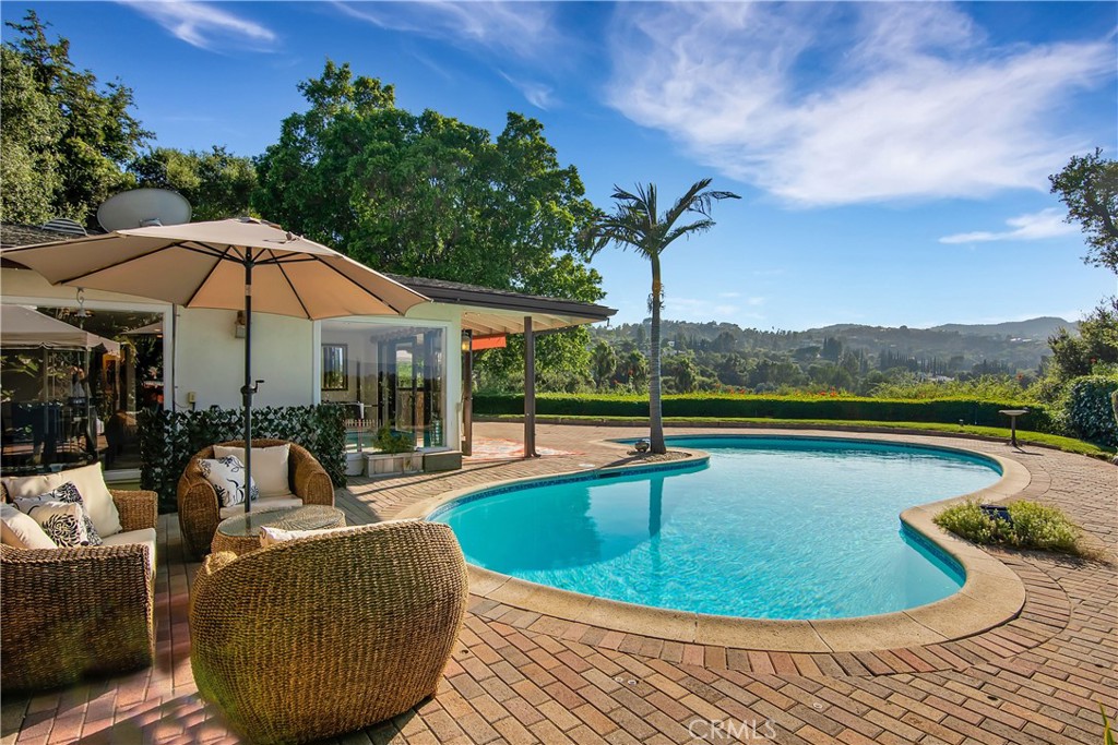 a view of a swimming pool with lounge chair