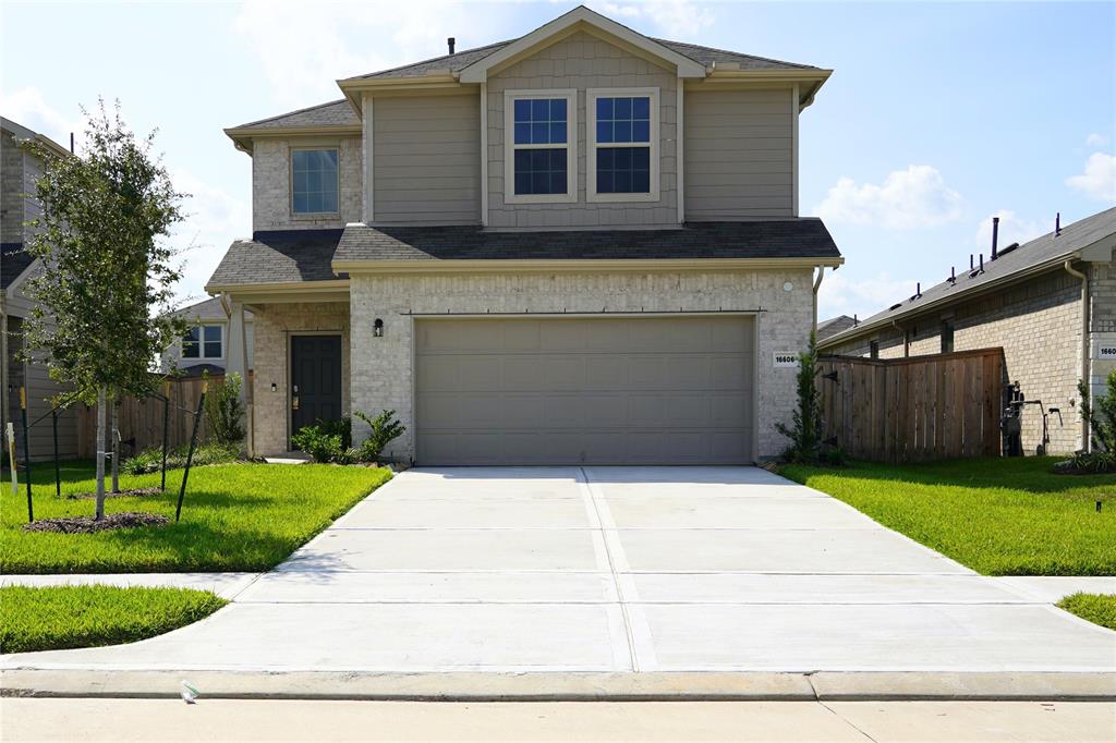 a front view of a house with a yard and garage