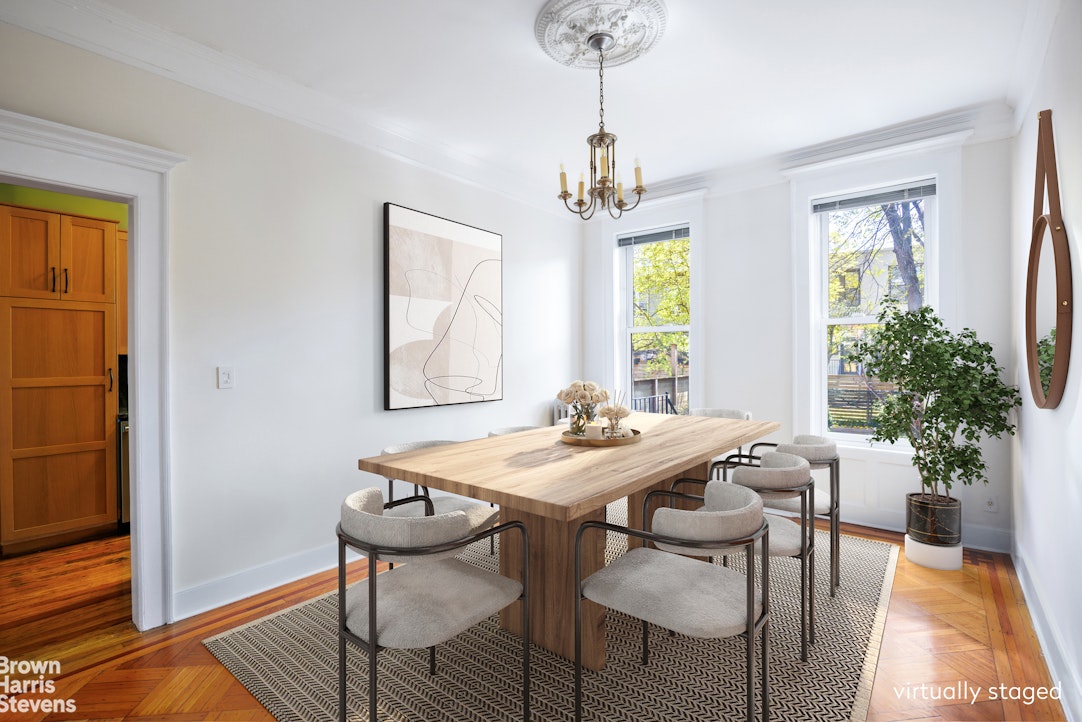 a view of a dining room with furniture window and wooden floor