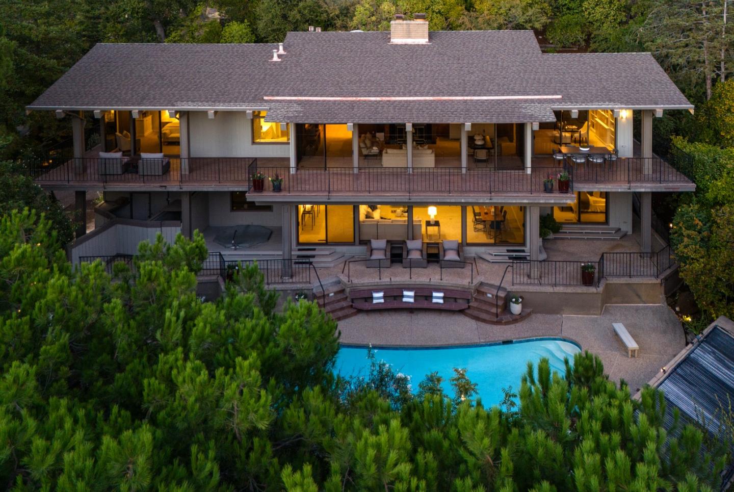 an aerial view of a house with swimming pool and patio