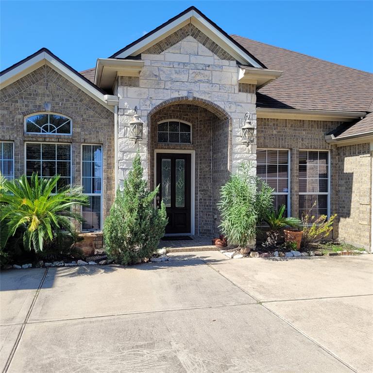 a front view of a house with plants