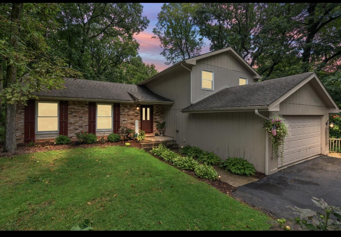 a front view of a house with swimming pool having outdoor seating