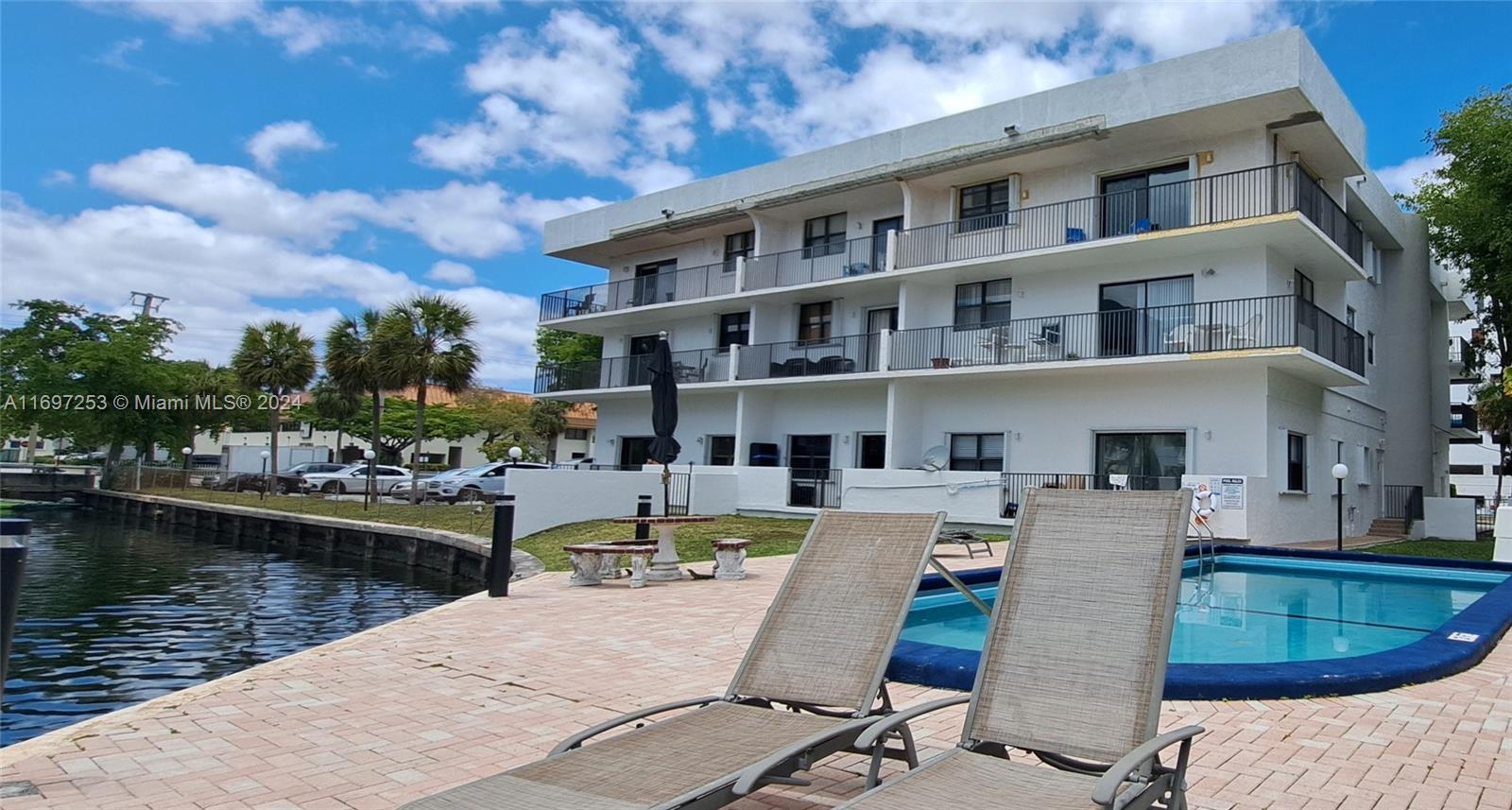 a view of a swimming pool with outdoor seating