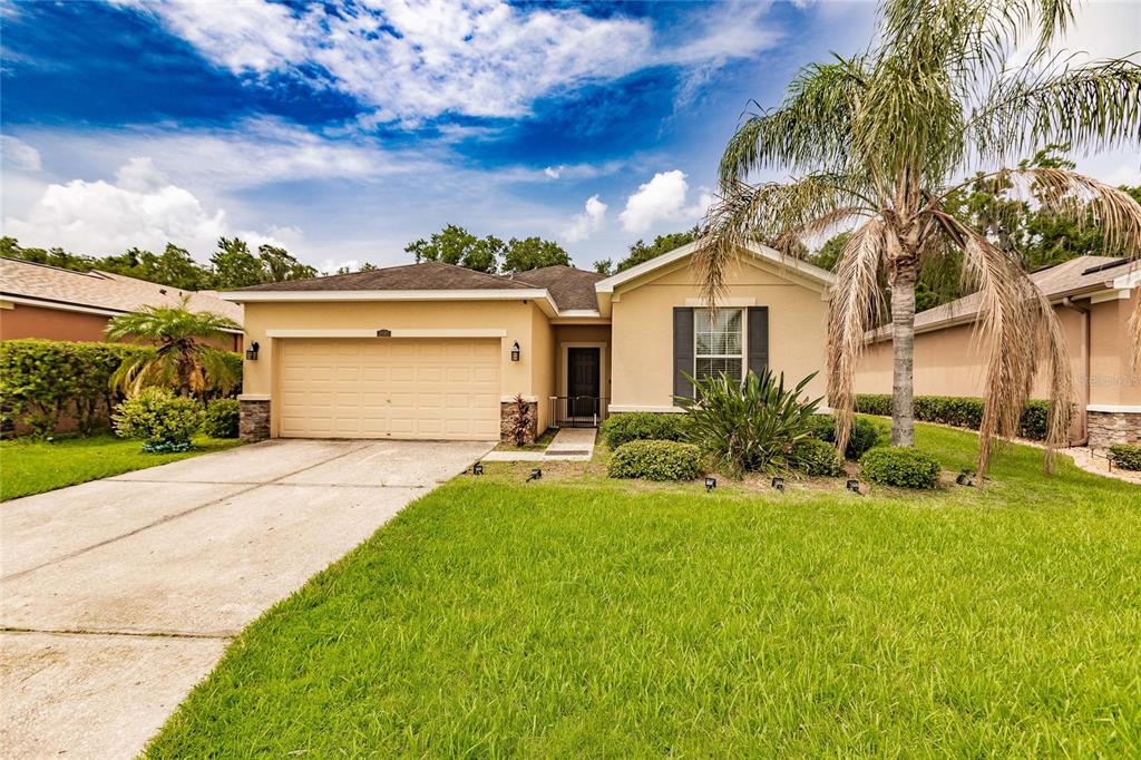 a front view of a house with a yard and garage