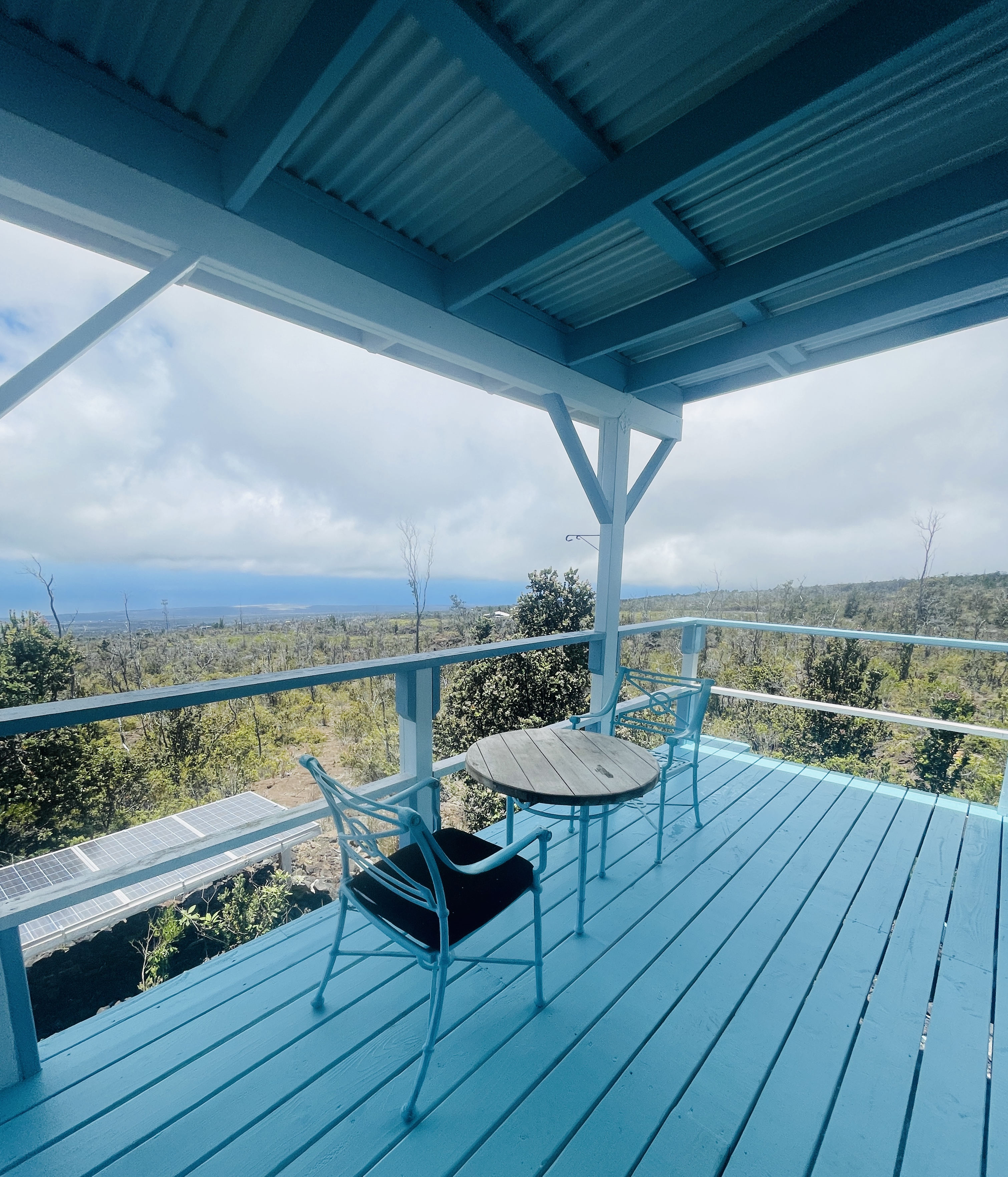 a view of a balcony with wooden floor and outdoor seating