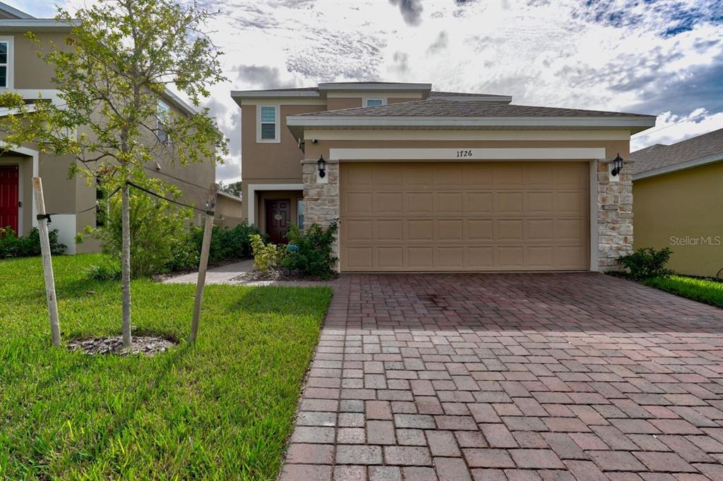 a front view of a house with a yard