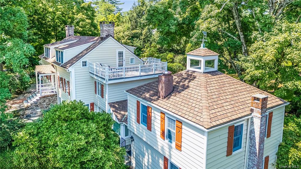 a aerial view of a house with a tub and balcony