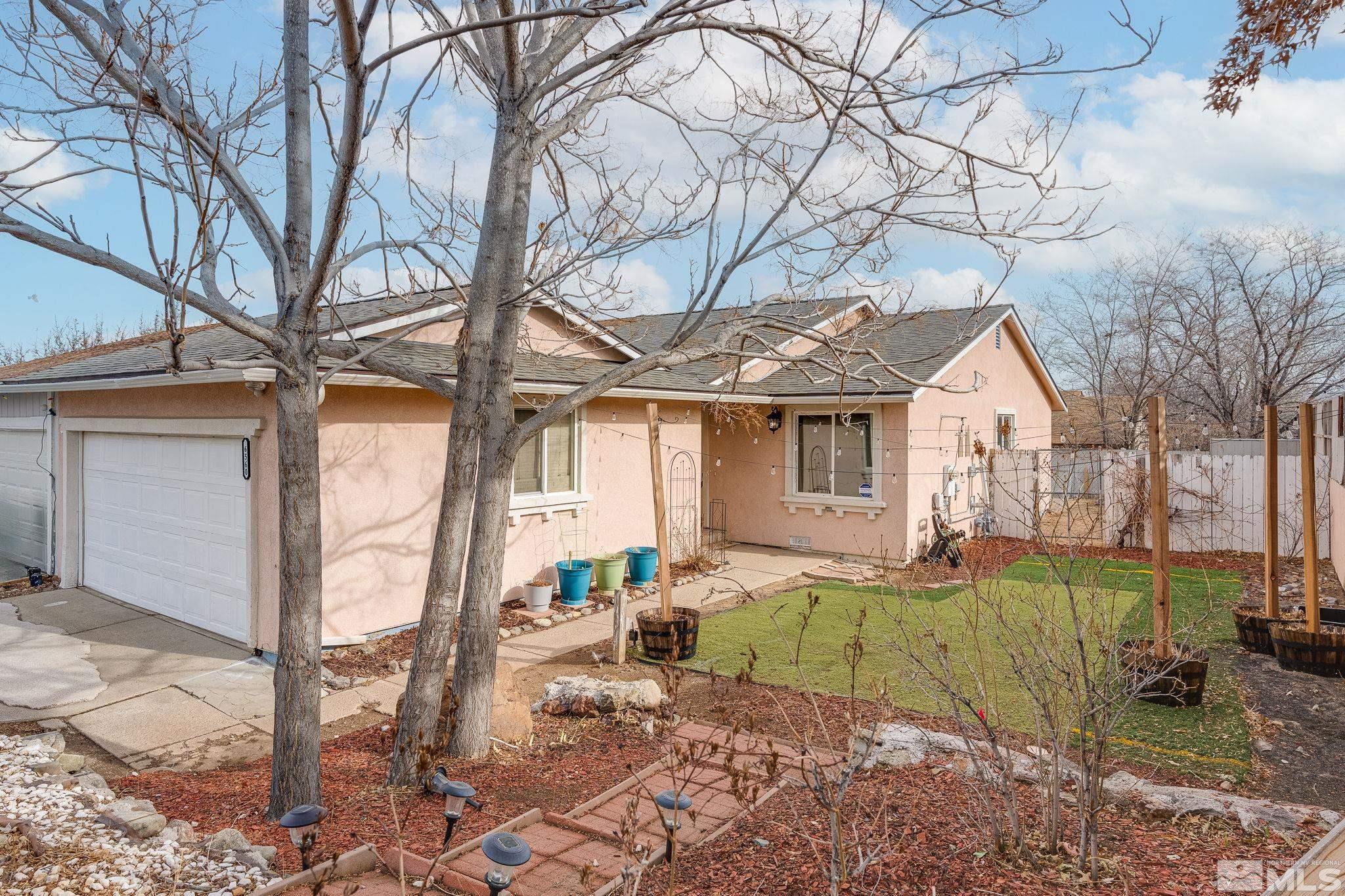 a view of a house with backyard and sitting area