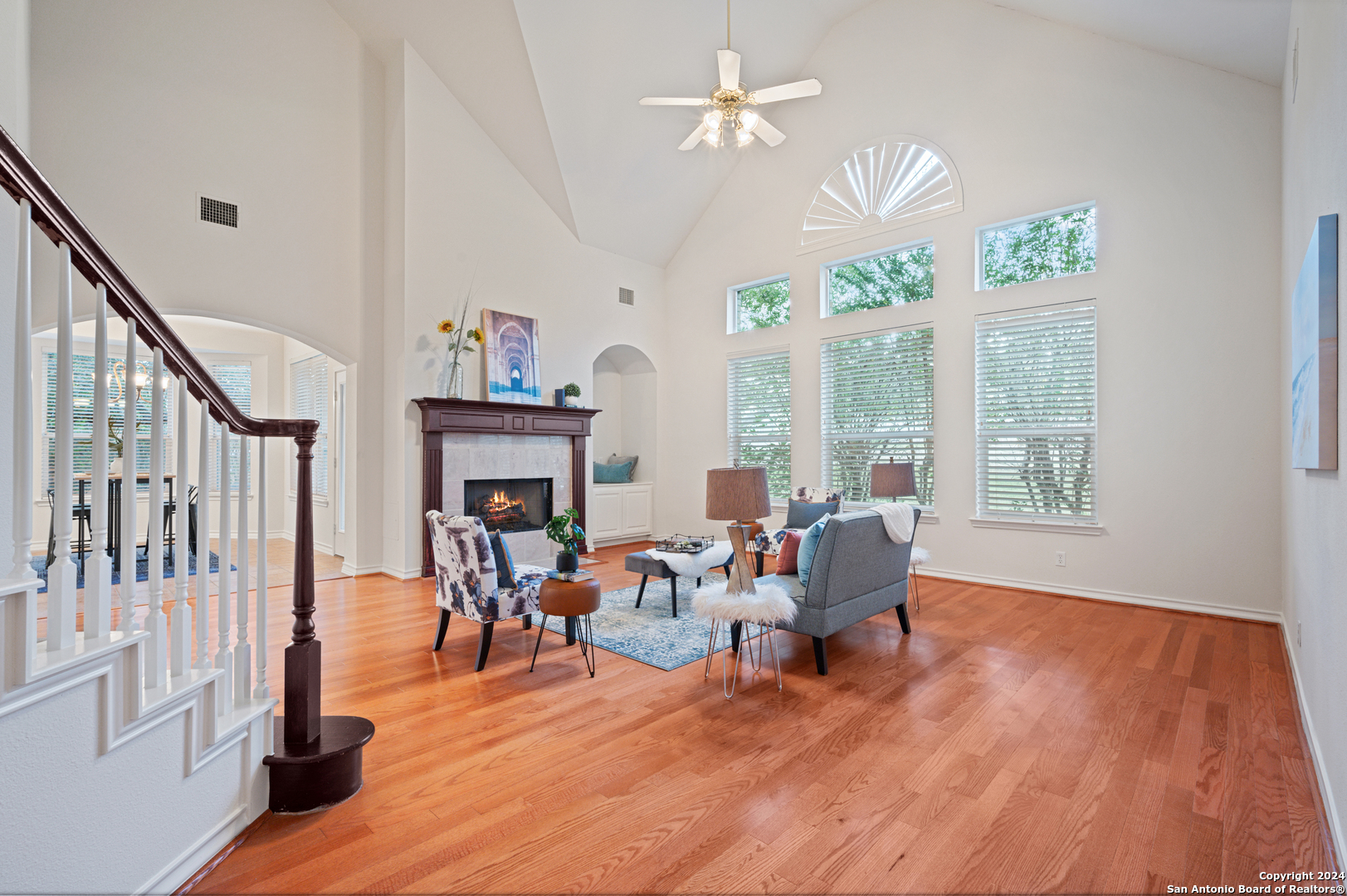 a living room with fireplace furniture and a wooden floor