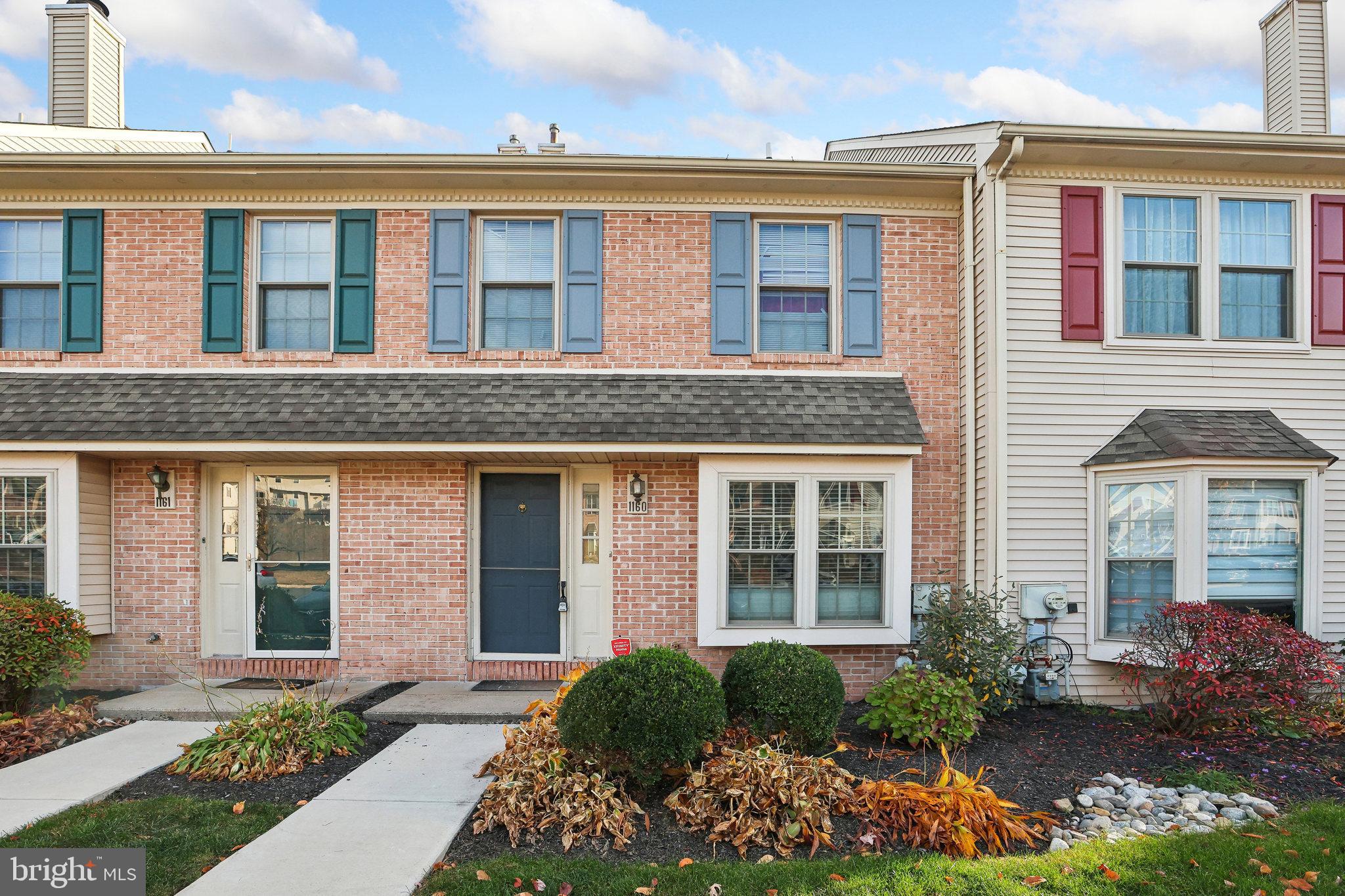 front view of a brick house with a yard