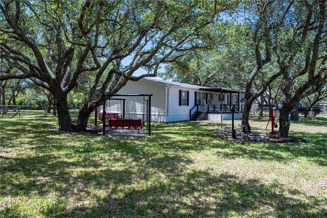 a view of backyard with tree and deck