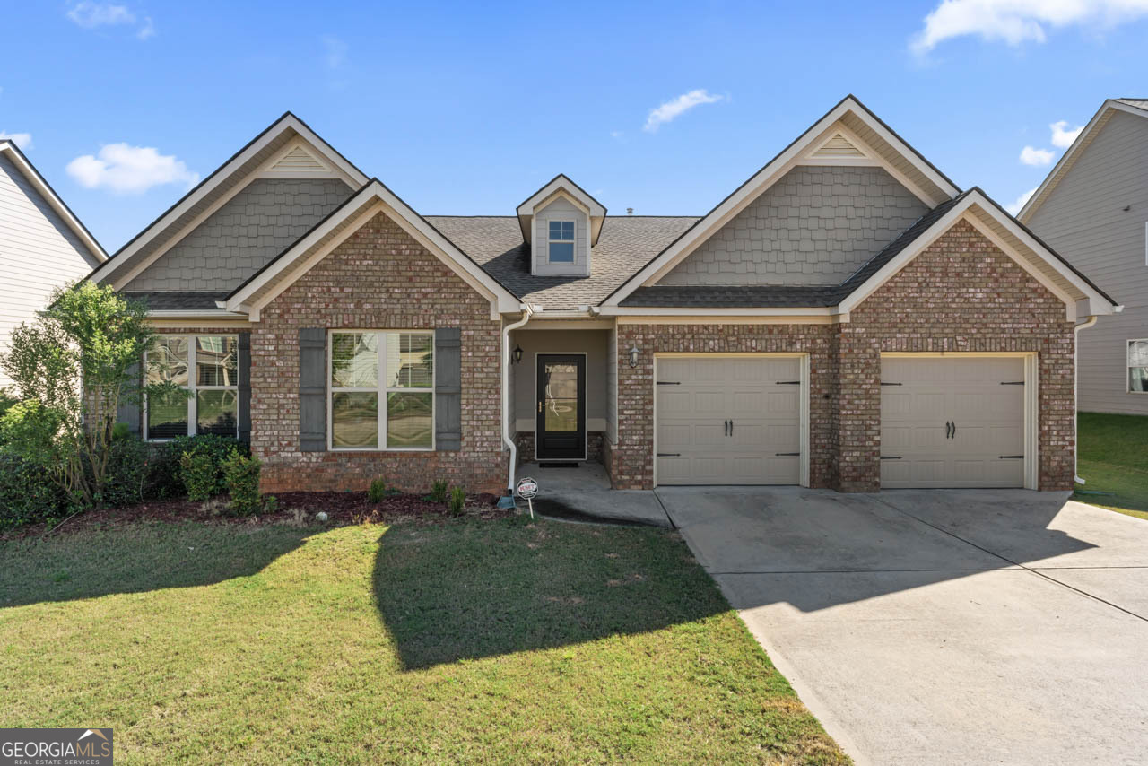 a front view of a house with a yard and garage