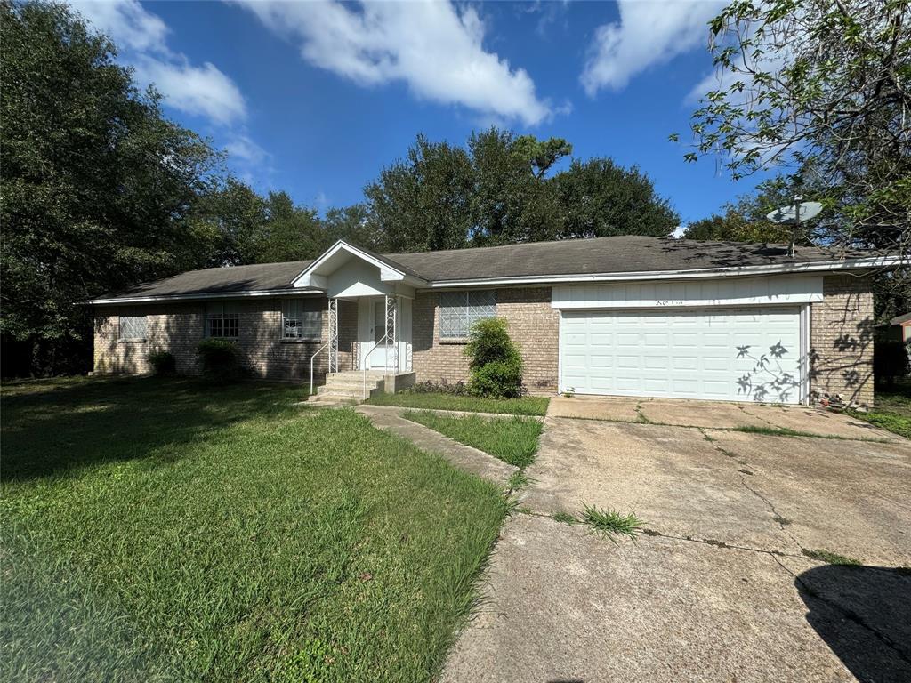 a front view of a house with a yard and trees