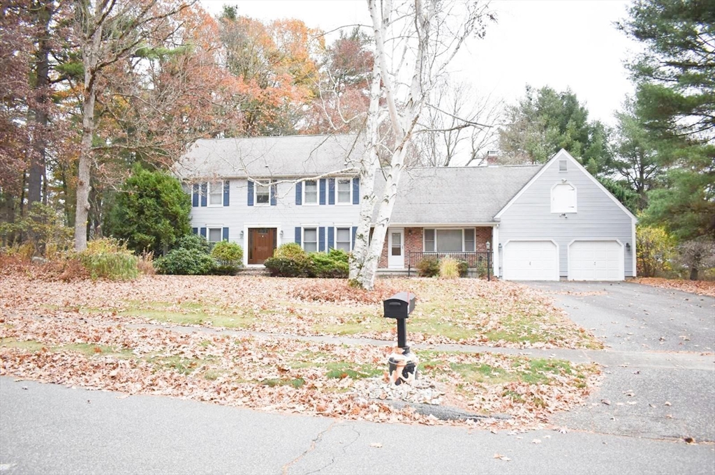 a front view of a house with a yard covered in snow