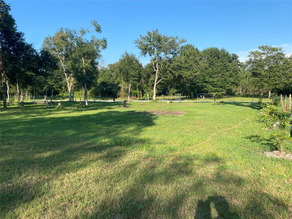 a backyard of a house with lots of green space and fountain