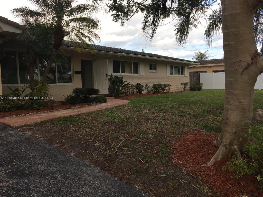 a view of a house with a backyard