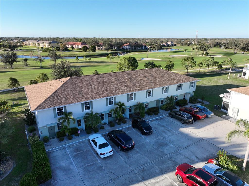 an aerial view of a house with garden space and lake view