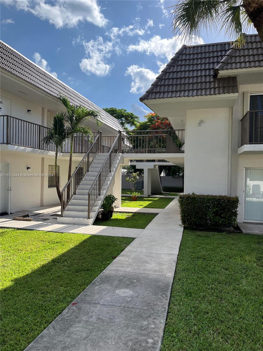 a view of a house with swimming pool and a yard