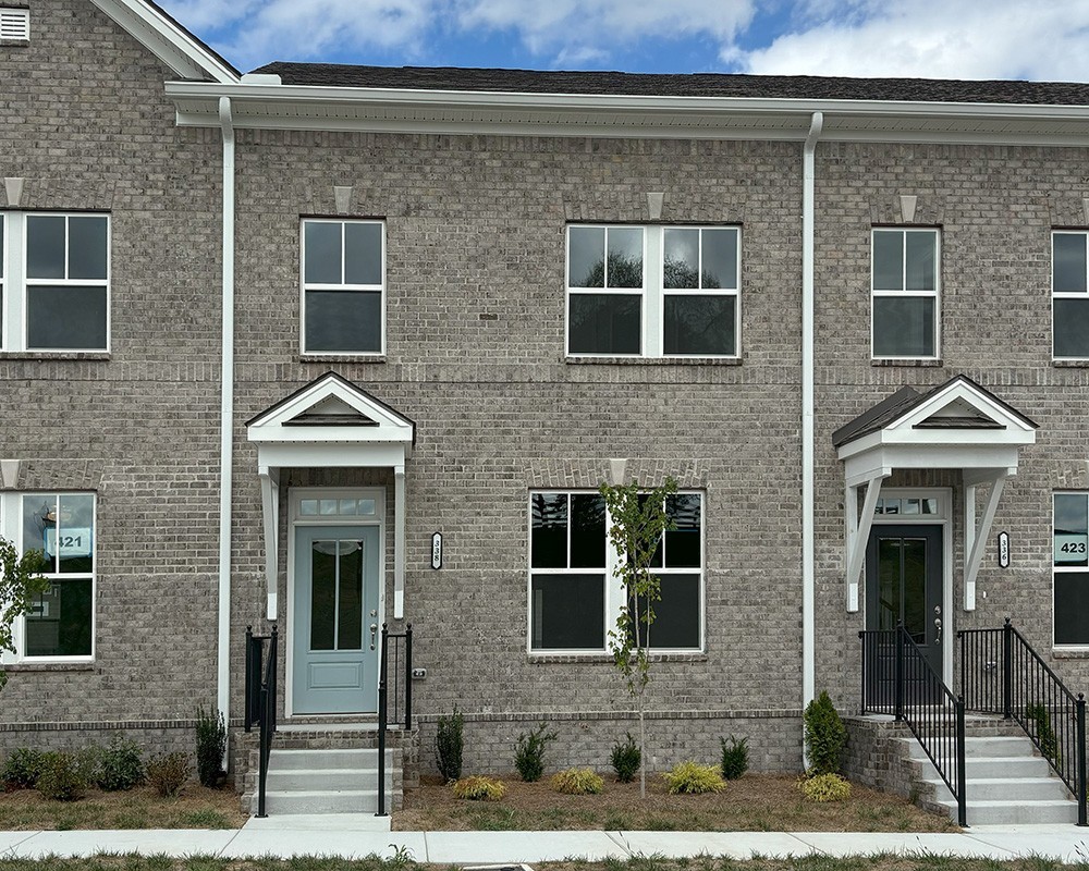 a front view of a house with yard