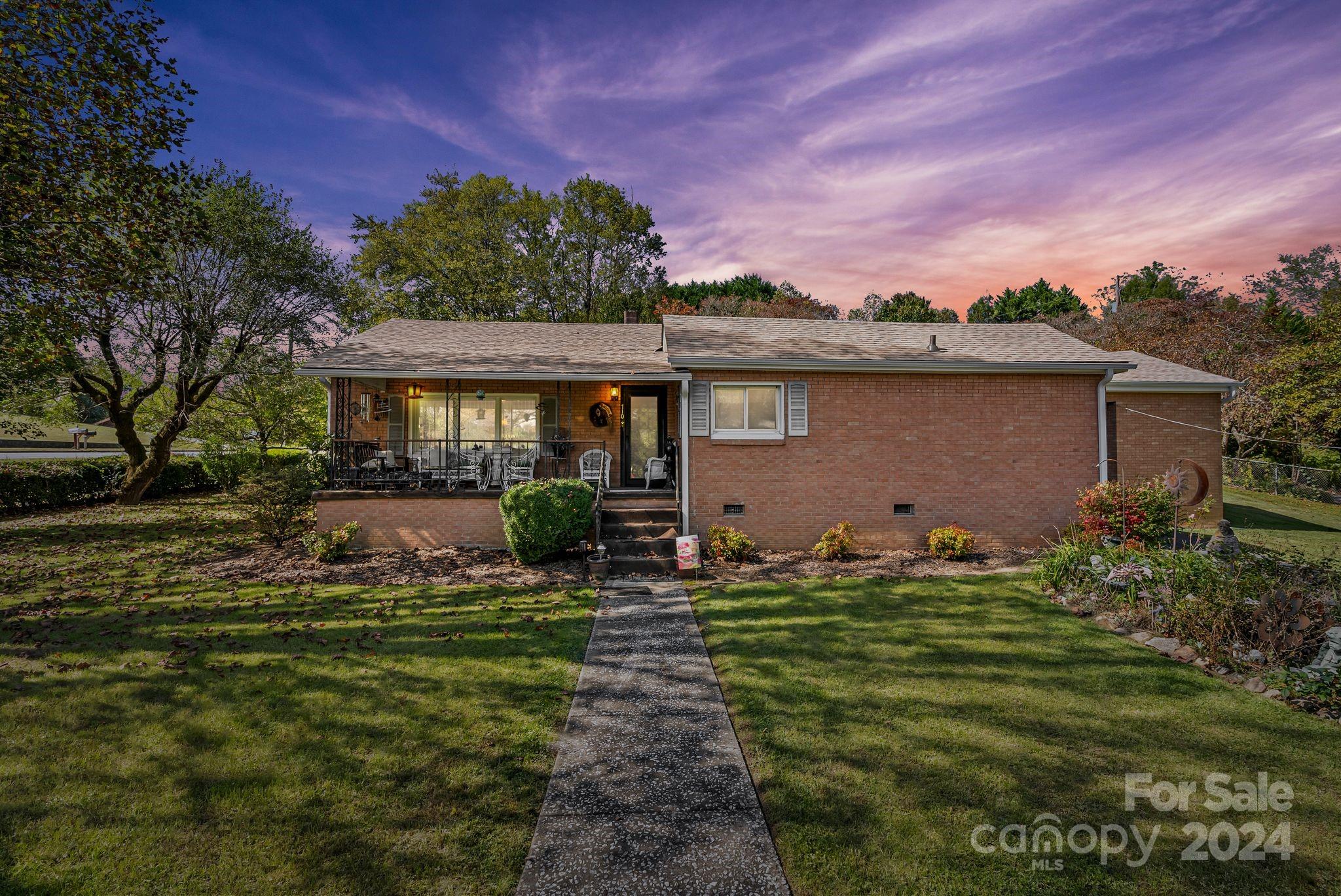 a front view of house with yard and green space