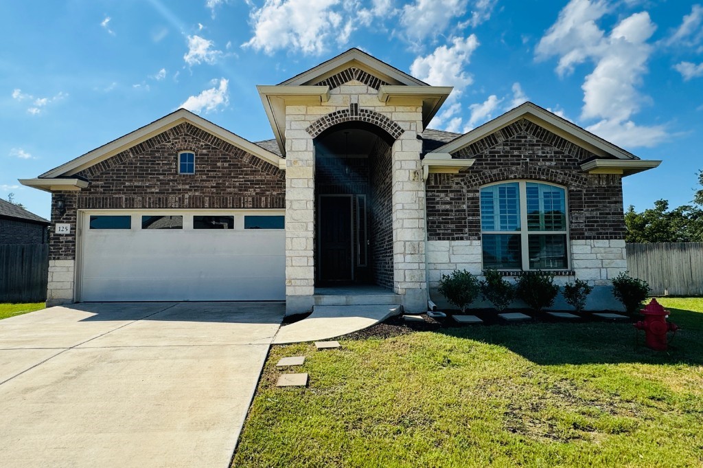 a front view of a house with garden