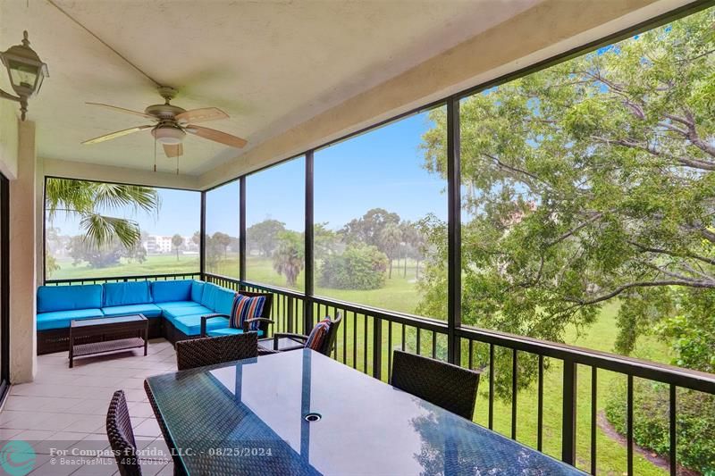 a balcony with furniture and a large window