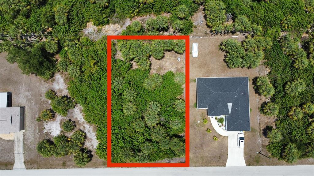 an aerial view of a house with a yard fountain and outdoor seating