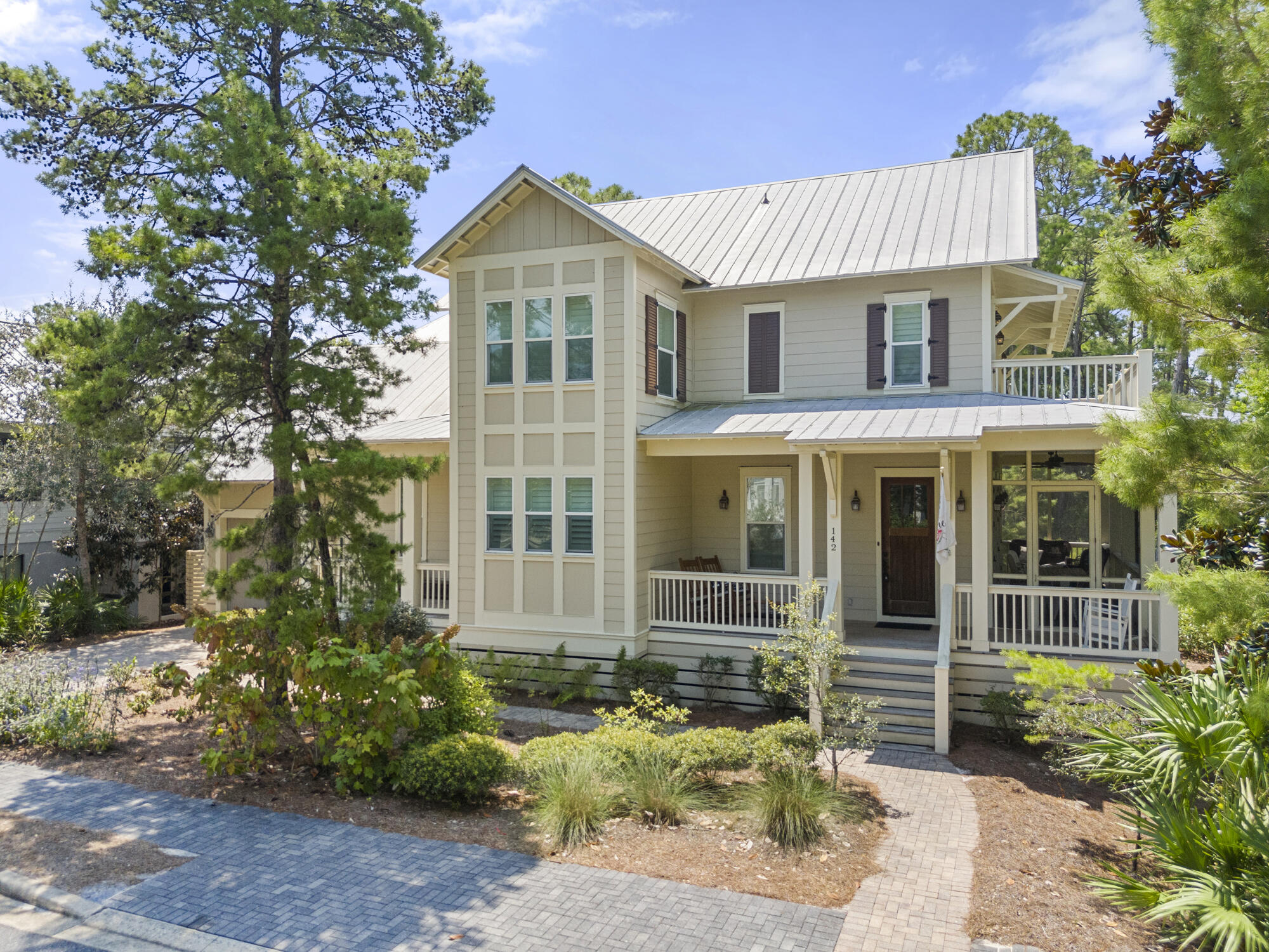 a front view of a house with a garden