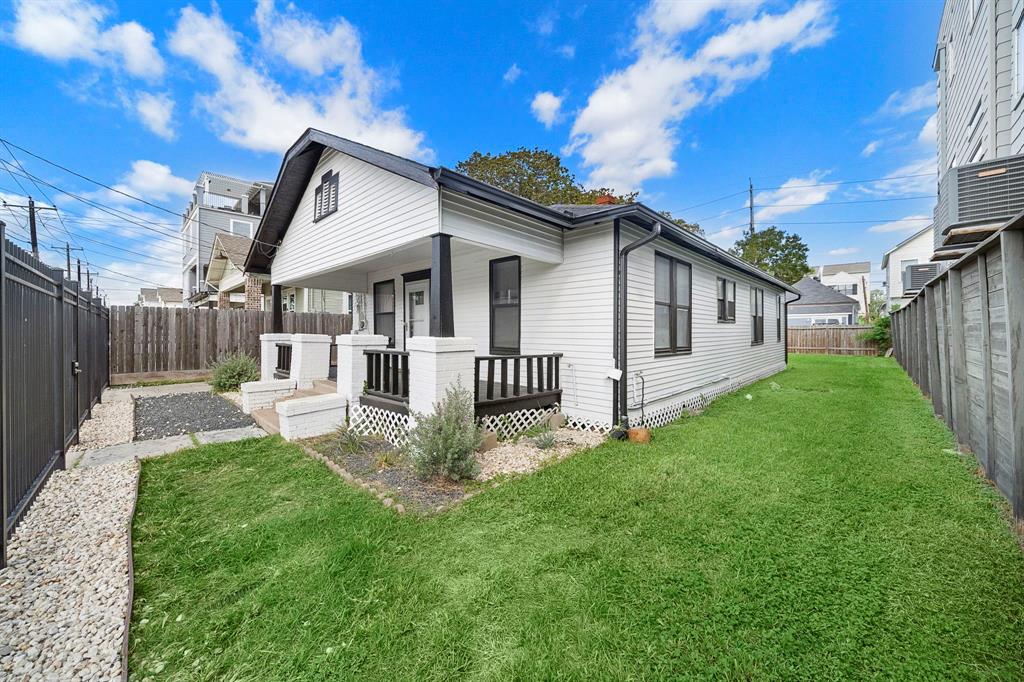 a view of a house with a yard and deck