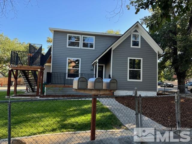 a front view of house with yard and outdoor seating