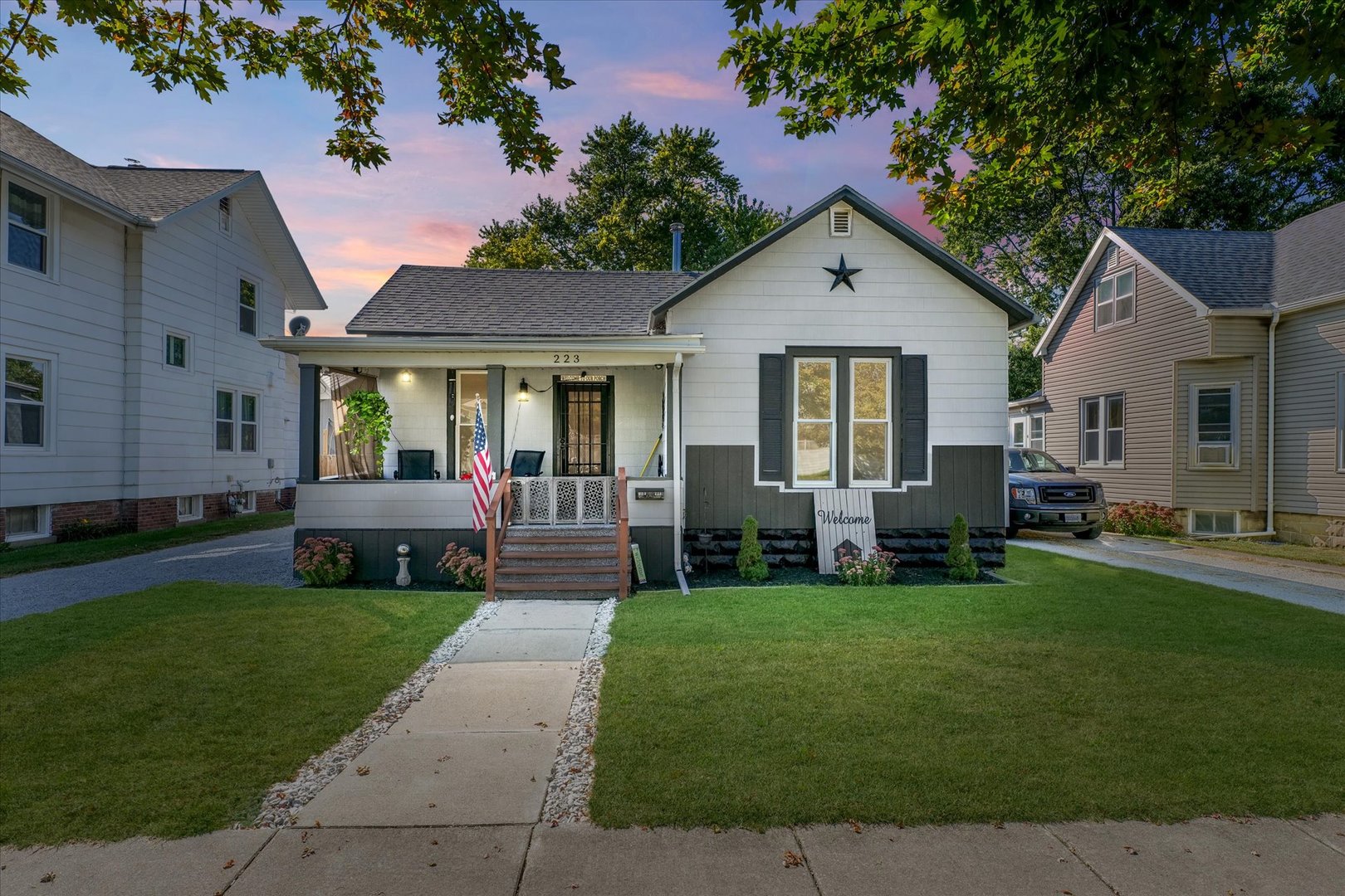 a front view of house with yard and green space