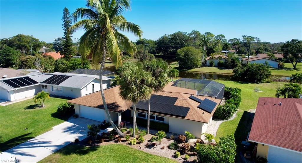 an aerial view of house with swimming pool outdoor seating and yard