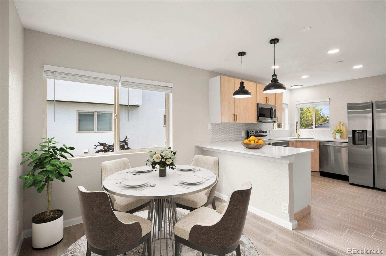 a kitchen with white cabinets and chairs