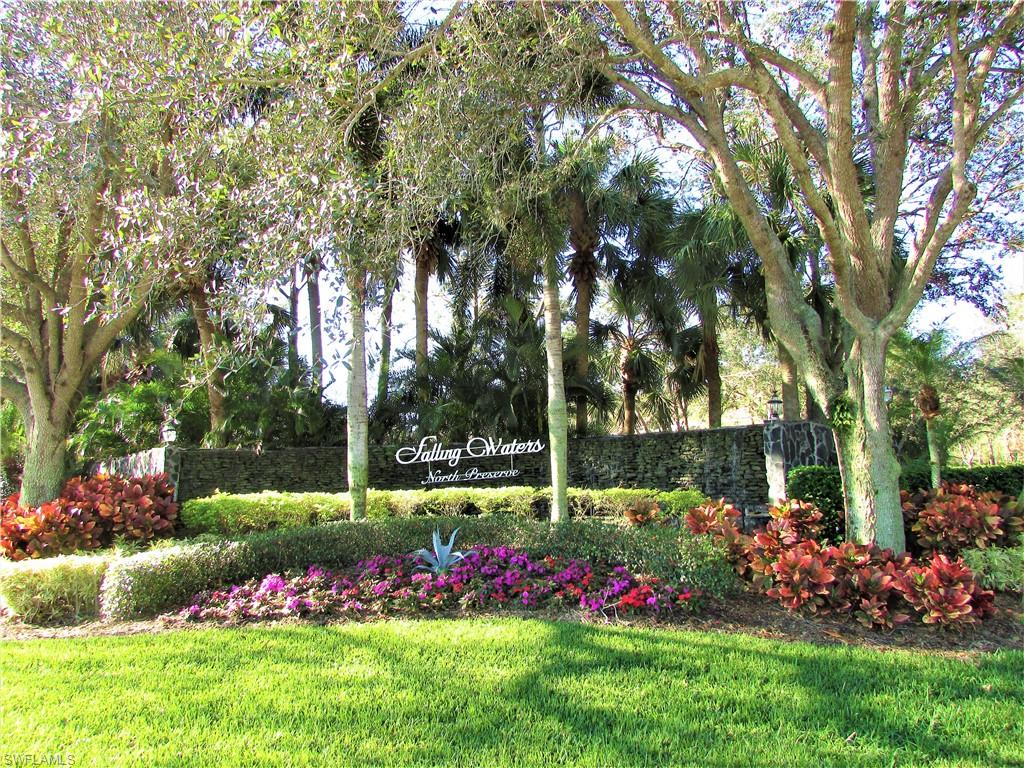 a view of a garden with flowers and trees