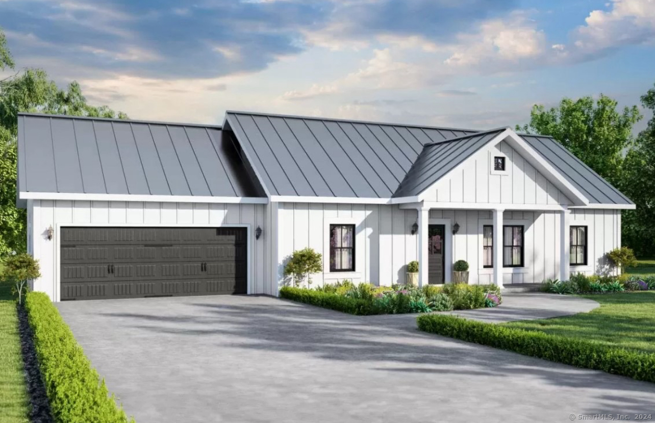 a front view of a house with a garden and garage