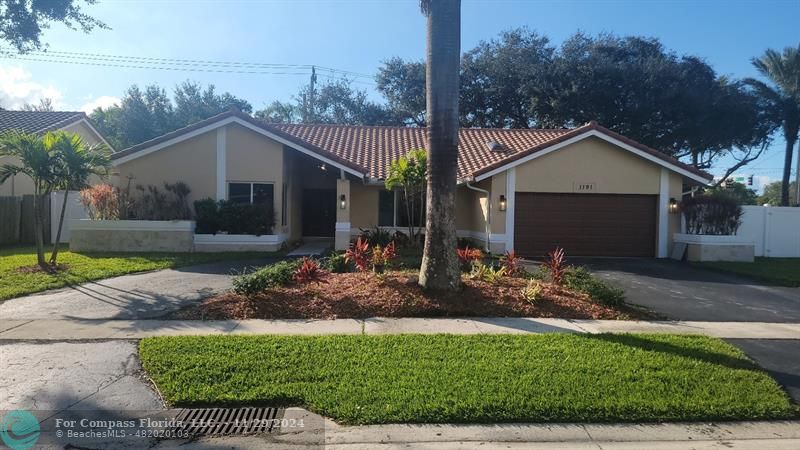 a front view of a house with garden